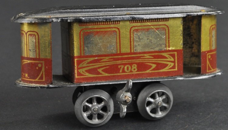 CARETTE TROLLEY TOY: Germany, small wind up toy done in lithographed tin, train truck wheels, open doors. 4" l.