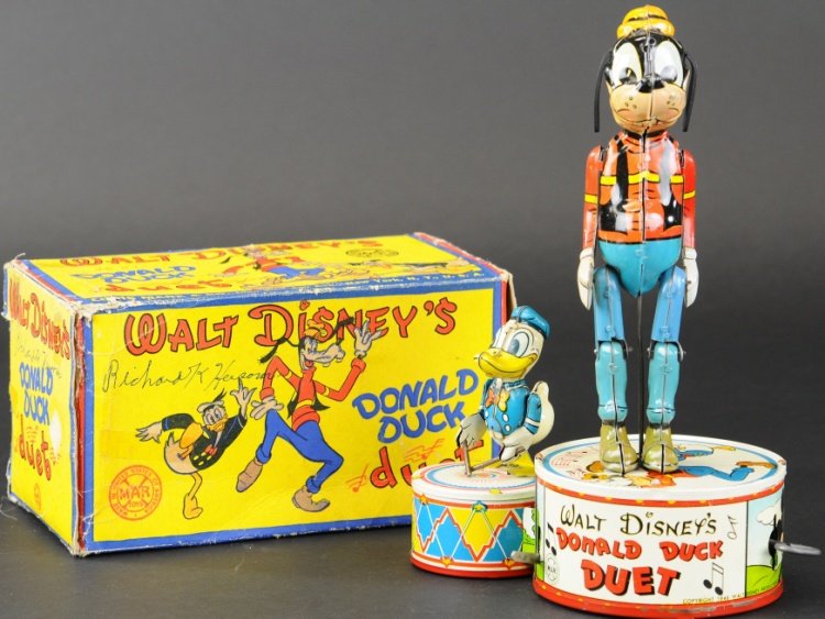BOXED DONALD DUCK DUET: Louis Marx, 1945, large Goofy and small Donald, lithographed tin, both depicted standing on large bass drums, clockwork activated. 9 3/4" h.