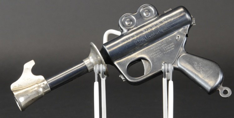 BUCK ROGERS DAISY TOY PISTOL: Pressed steel, gun blue with extensive debossed lettering, futuristic design. 9 1/2" l.