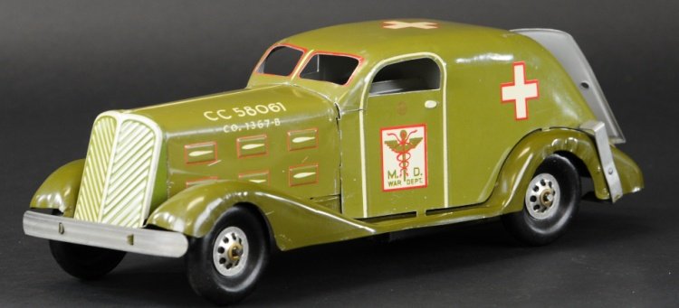 MARX ARMY AMBULANCE: Lithographed tin and pressed steel fenders done in olive green, wind up action, medical insignia and M.D. War Dept. graphics on door, white and red crosses on roof and sides. 14" l.