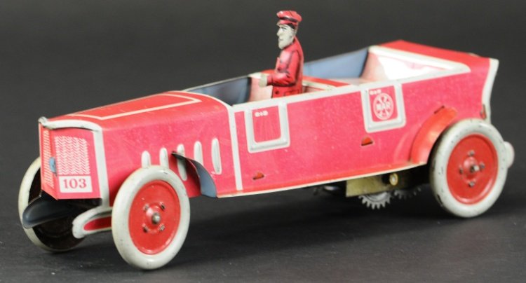 MARX TOURING AUTO: Lithographed tin, done in red body, white trim, seated driver, disc wheels have red centers, wind up action. 9 3/4" l.