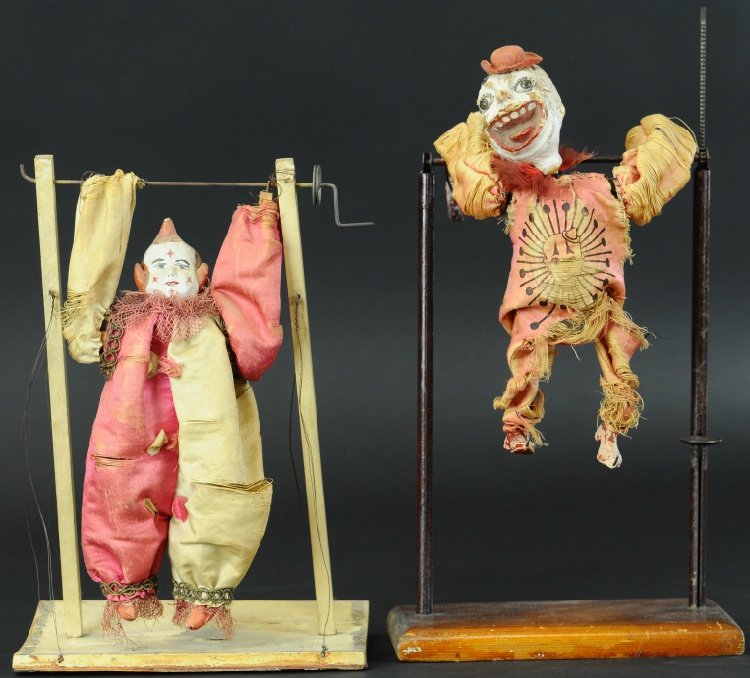 LOT OF TWO CLOWN GYMANSTS: Each with composition head and cloth outfit, both depicted on high bar with hand controlled actions. Approx. 12" h.