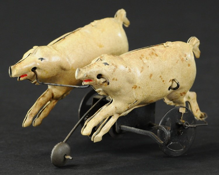 TWO PIGS WIND UP TOY: Germany, features two hand painted pigs seemingly walking along at fast pace when wind up is activated.
