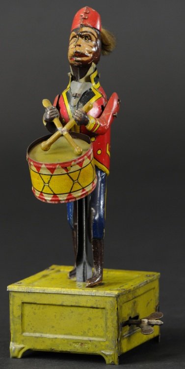 DISTLER DRUMMING MONKEY: Germany, lithographed tin monkey drummer with working clockwork, pre-war, c. 1920's, very colorful toy able to hit drum with sticks. 8 1/2".