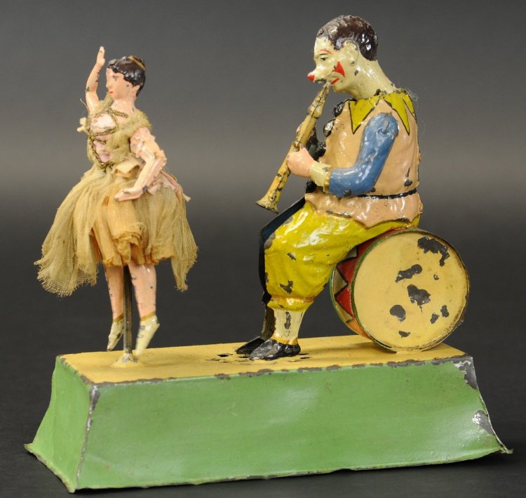 GUNTHERMANN MUSICIAN & BALLERINA: Germany, early hand painted example, bright colors, clockwork activates twirling motions of dancer as plink-plink sounds emit from shared base, dancer depicted in cloth tu tu.