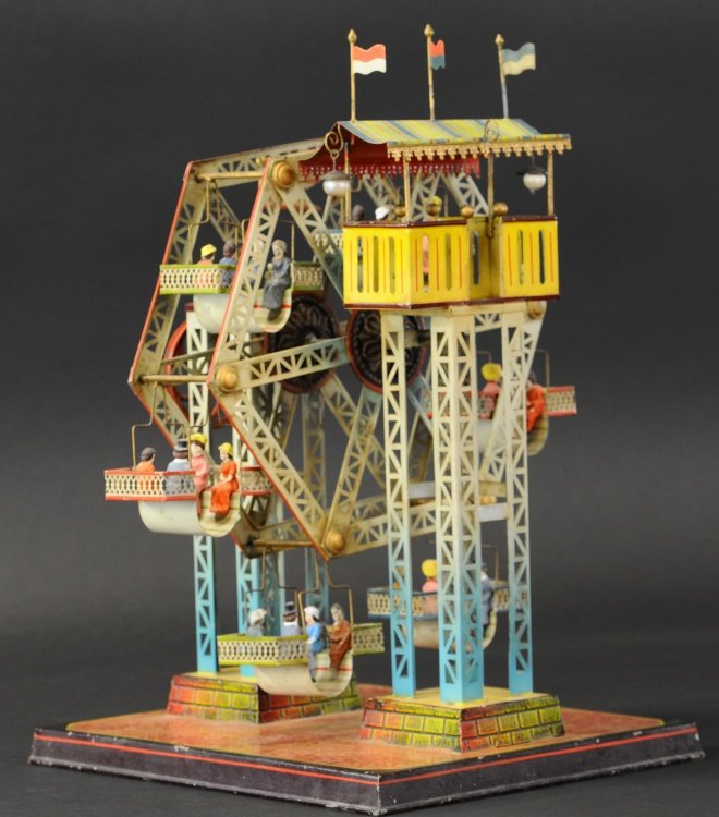 DOLL ET CIE FERRIS WHEEL: C. 1904, very nicely detailed example, Doll et Cie ferris wheel from Germany is exquisitely hand enameled in rainbow colors, features working hand crank mechanism and composition figures, complete wit