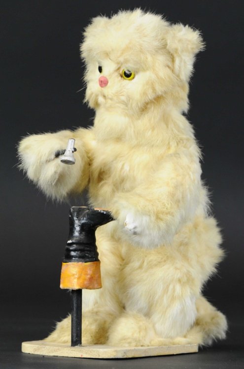 DECAMPS BOOT MAKER BEAR AUTOMATON: France, hide covered mechanical activated bear with glass eyes, bear appears to be working on boot as he taps hammer on its heel, amusing action, includes R&D integral key. 12 1/2" h.