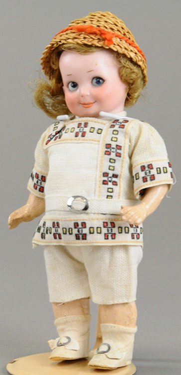 CHARMING ALL ORIGINAL A.M. GOOGLY: Smiling socket head incised 'G.253B. Germany A. 10/0 M,' with side glancing blue glass sleep eyes, deep dimples on five piece comp toddler body with bare feet, original clothing, shoes, wig (spade) an