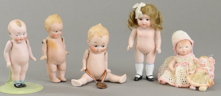 LOT OF SIX GERMAN ALL BISQUE DOLLS: Included are Kestner 150 with closed mouth, bye-lo with painted eyes and stationary neck, wide awake doll, two Kewpie type dolls, one with jointed legs and a very small infant doll with movable limbs.