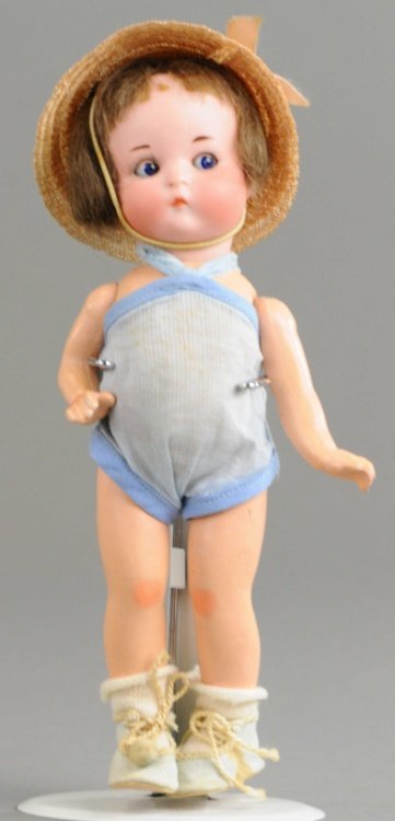 JUST ME' CHARACTER DOLL: Head incised 'A 310 10/0 M, Just Me, Germany,' with sleep eyes, original five piece composition body, original wig, and clothing, good bisque body and finish. 7 1/2" (19 cm).