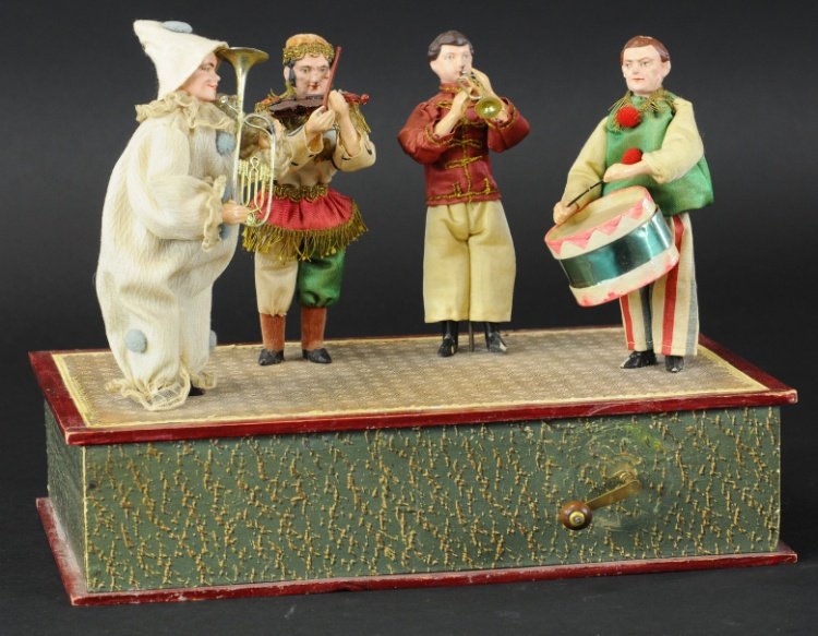 MUSICAL FIGURES CRANK TOY: Four musician figures on shared base with mechanical action when front crank is turned, depicts amusing costumed figures, each with an instrument in hand.