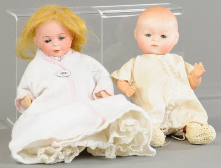 TWO GERMAN BISQUE HEAD DOLLS: Larger 'Dream Baby' type incised 'RA,' has glass sleep eyes and five piece toddler body, smaller with glass sleep eyes, closed mouth on five piece bent limb body by Swaine & Co., incised 'FP.' 7 1/2" 