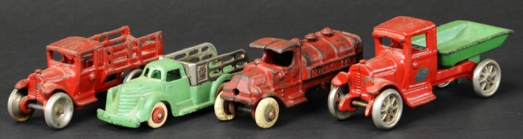 ASSORTED CAST IRON VEHICLES: Grouping of trucks includes Arcade stake and dump truck, Champion gas truck and Hubley stake truck with nickel stake body. 5" - 6" l.