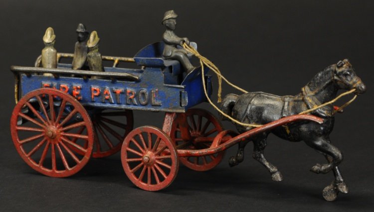 HORSE DRAWN FIRE PATROL WAGON: Hubley, cast iron, large open bed wagon with driver and seated figures on open bench seating, embossed 'Fire Patrol' on sides, red spoke wheels and hitch frame, drawn by one horse. 19" l.