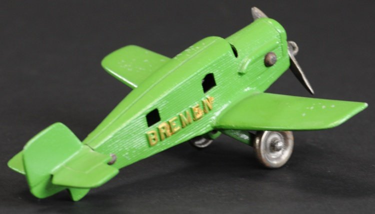 BREMEN 'JUNKERS' AIRPLANE: Hubley, c. 1933, cast iron, painted in green overall, embossed lettering, cast ribbed fuselage, nickeled disc wheels, seated pilots, single nickel prop. 6 1/2" l.