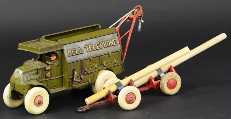 HUBLEY MACK BELL TELEPHONE TRUCK: Cast iron, painted in familiar olive color, water tank on side, includes pole trailer and A-frame hoist. 9" l.