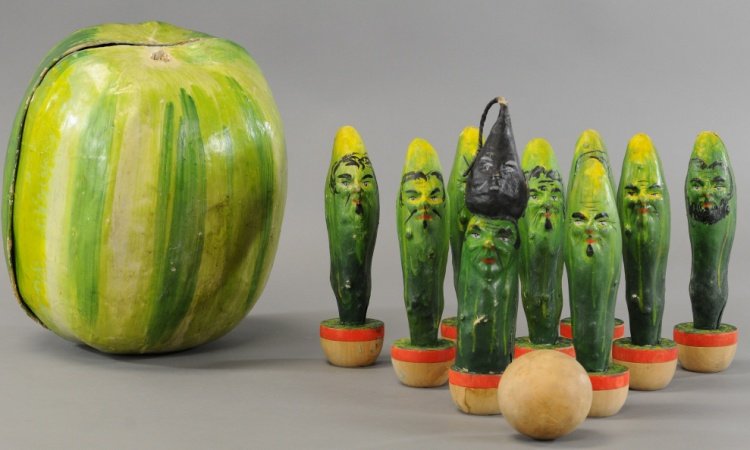 VEGETABLE SKITTLES AND MELON HOLDER: Hand painted papier mÃ¢chÃ© cucumbers with human character faces, center piece depicted with turnip on head, pieces are able to be stored in large watermelon piece.