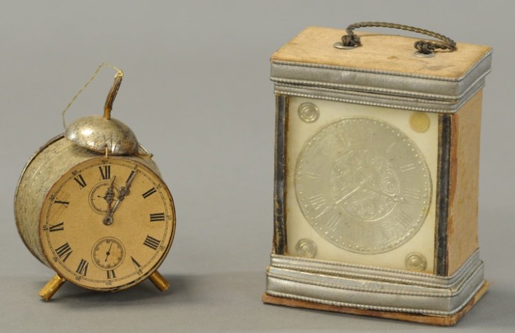 TWO DRESDEN CLOCKS: Two German Dresden clocks in the form of candy containers, the mantel clock opens from the base, the alarm clock opens from the rear. 2" to 3". Ex. Tom Fox Collection