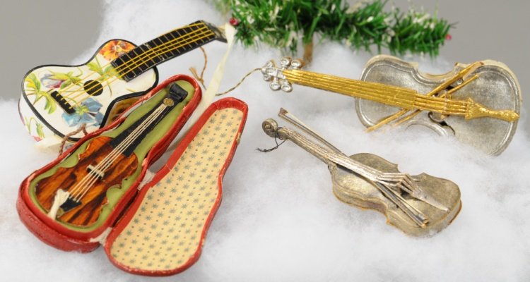 THREE VIOLINS AND A GUITAR: Four Dresden ornaments including gold string violin candy container, silver violin, violin in its case and guitar candy container. 3 1/2" to 4 1/2". Ex. Tom Fox Collection
