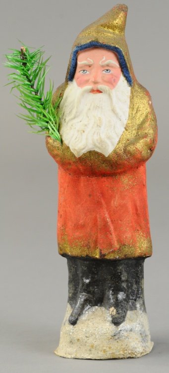 COMPOSITION GERMAN BELSNICKLE: Wears red robe with gold trim, blue felt around head, holds feather tree sprig in arm. 8 1/2" h. Ex. Tom Fox Collection