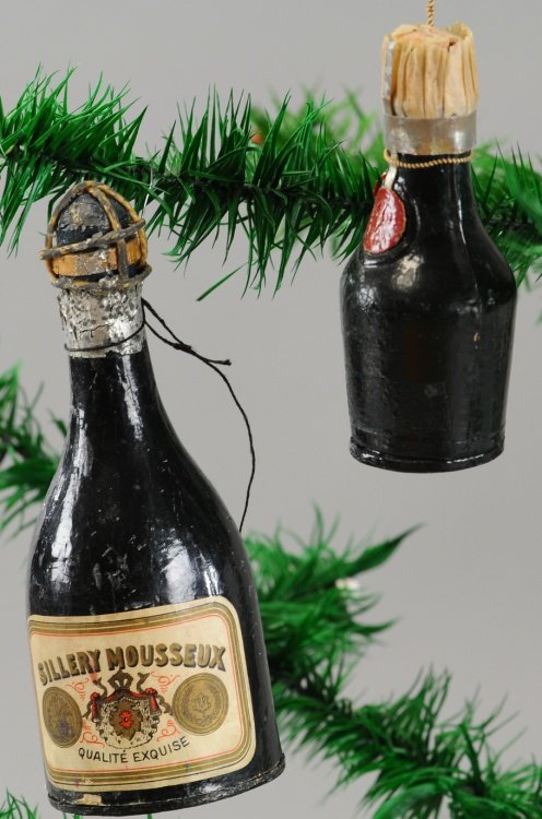 TWO CHAMPAGNE BOTTLE CANDY CONTAINERS: Germany, Dresden, Sillery Mousseux bottle and wax seal bottle candy containers. 3" to 5". Ex. Tom Fox Collection