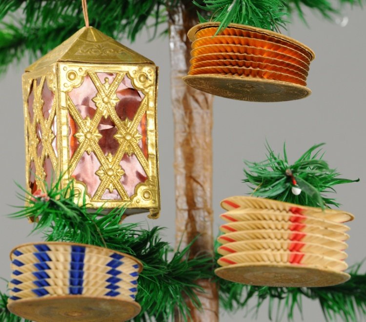 FOUR GERMAN DRESDEN LANTERNS: Three accordion type lanterns and a four square lantern with red cellophane windows. 2" to 3". Ex. Tom Fox Collection