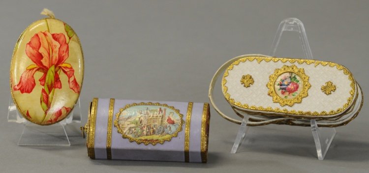 THREE ATTRACTIVE CANDY BOXES: White handled purse embellished with flowers and elaborate trim, lavender dowered box with classical scene and oval box with iris and Dresden trim. 2 1/2" to 3 1/4". Ex. Tom Fox Collection