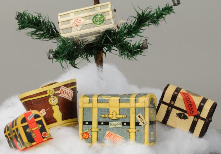 GREAT LOT OF FIVE TRAVEL LUGGAGE CANDY CONTAINERS: Four domed trunks, two with applied scrapping, and brown hat box. 2" to 2 1/2". Ex. Tom Fox Collection