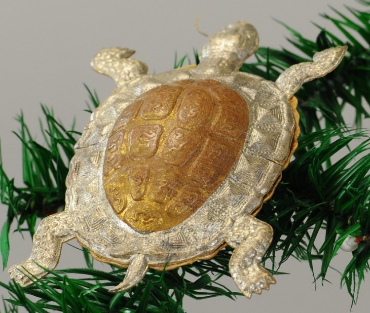 DRESDEN TURTLE CANDY CONTAINER: A gold and silver turtle with an opening at the front underside of shell with the remains of a candy bag. 3 1/2". Ex. Tom Fox Collection