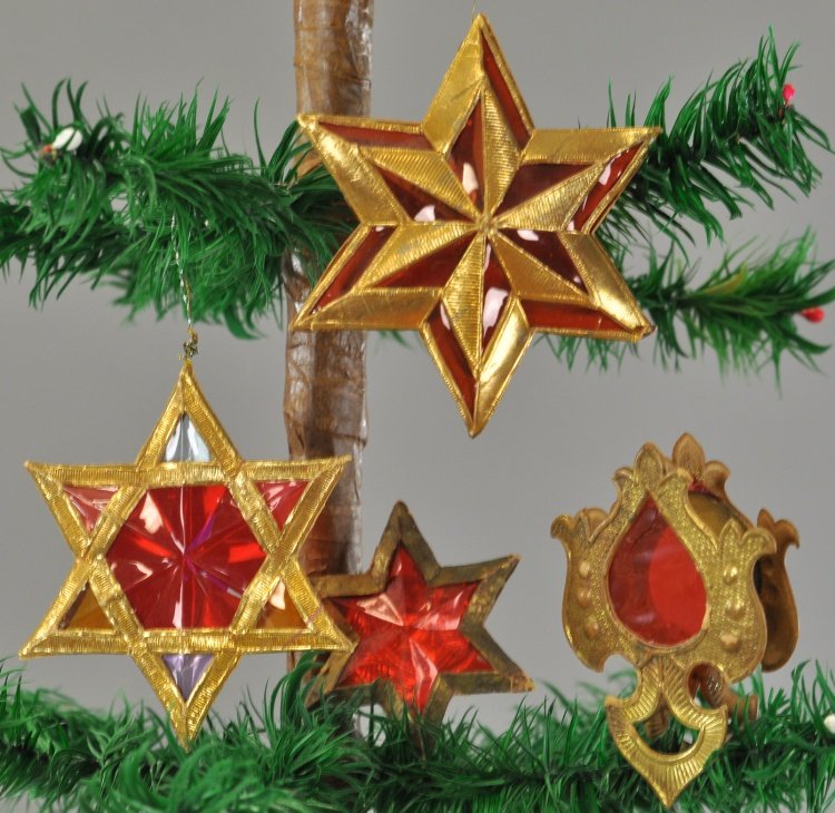 FOUR GOLD DRESDEN ORNAMENTS: Three puffed stars and one candy container with red gel inserts. 2 1/2" to 3 1/2". Ex. Tom Fox Collection
