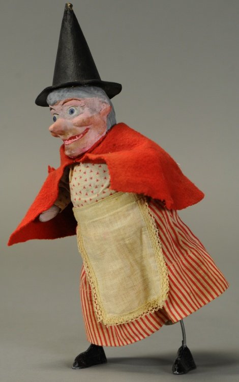 MECHANICAL SUITED WITCH: Germany, composition, tall witches hat, red cape over period dress, clockwork allows wobbling motions. 11".