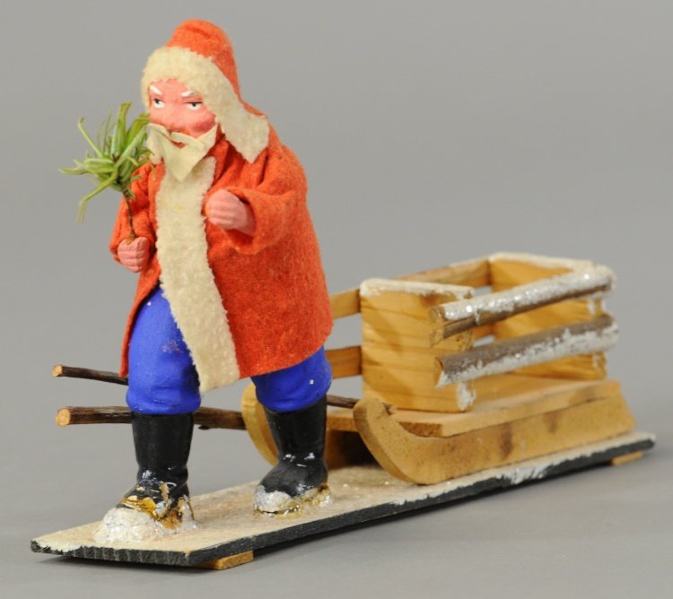 SANTA PULLING WOODEN SLEIGH: Germany, composition Santa Claus in red robe, trudging through the snow pulling a mica flecked wood sleigh. 9".