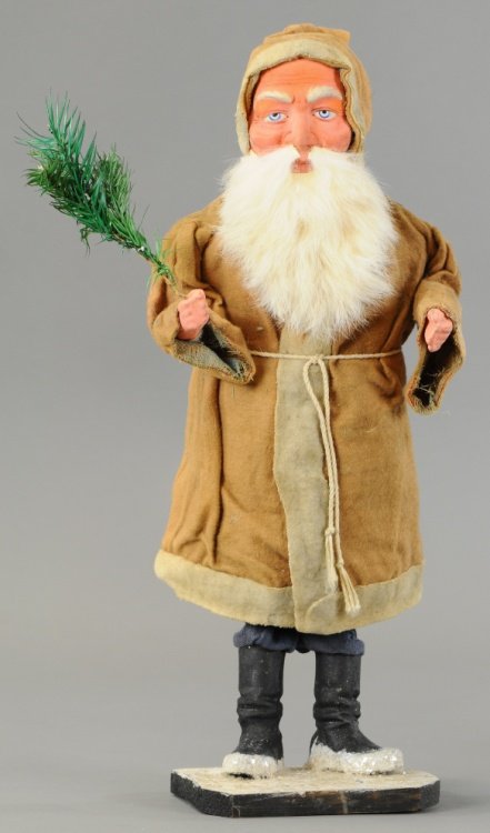 BOBBING SANTA IN BROWN ROBE: This jolly Santa Claus has cardboard body with composition legs, hands and face that sports a rabbit fur beard, he is holding a feather tree sprig and he bobs and bounces with the slightest touch. 17"