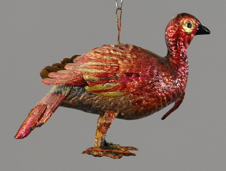 COLORFUL IRIDESCENT TURKEY DRESDEN ORNAMENT: A unique example of a well detailed turkey with dramatic intense red and gold coloring. 3". Ex. Tom Fox Collection