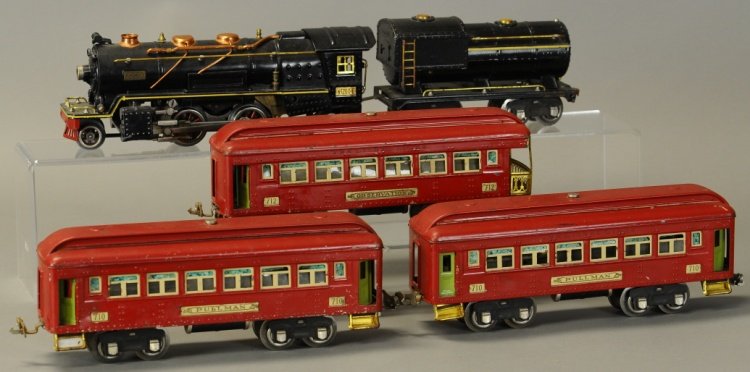 LIONEL 'O' GAUGE No. 260E PASSENGER TRAIN SET: Pre-war set includes #260E black locomotive with #260T tender, together with three red passenger cars consisting of two #710s and one #712. Loco 12" l.