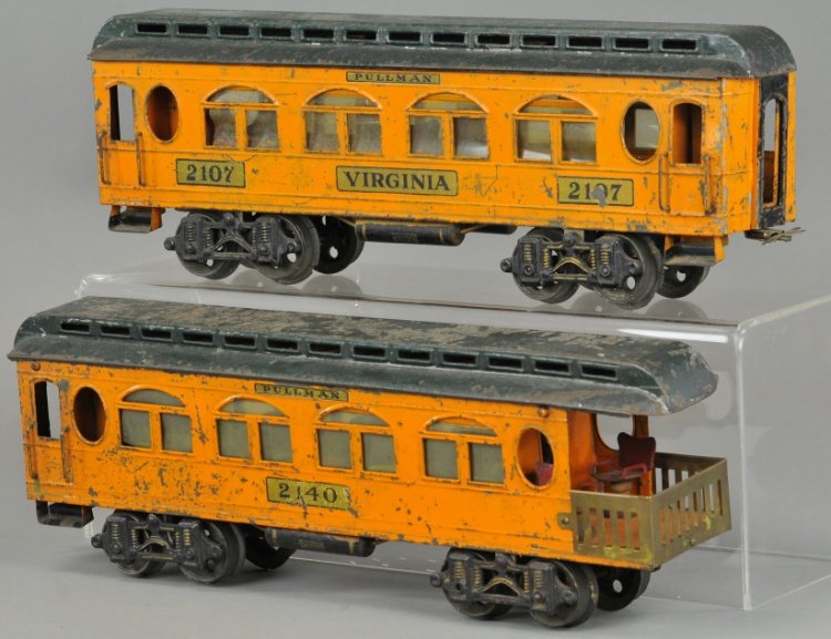 LOT OF TWO VOLTAMP CARS: c. 1919-1923, includes #2107 Virginia pullman, and #2140 observation car, both done in orange body with green roof, decals on sides, celluloid windows. 16" l.