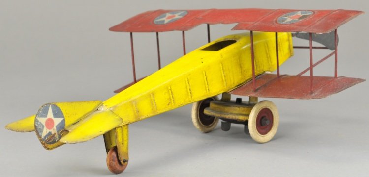 KINGSBURY AIRPLANE: Stamped tin, bi-plane done in yellow fuselage and red wings, clockwork driven. 11 1/2" wing.