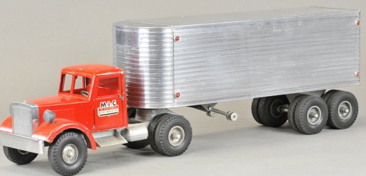 M.I.C. TRACTOR & TRAILER: 1950's model, die cast tractor done in red overall with unmarked aluminum trailer body, disc wheels, rubber tires, decals on doors.