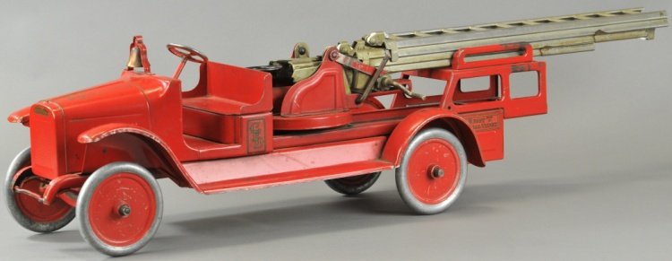BUDDY 'L' AERIAL FIRE TRUCK: Pressed steel, painted in red overall, open bench seat cab, features nickel extension ladder, aluminum disc wheels. 39" l.