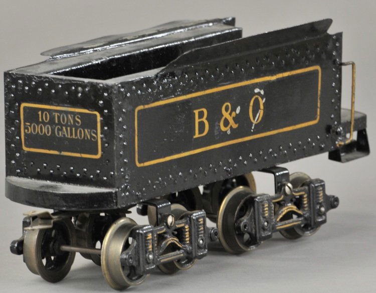 VOLTAMP No. 2192 EIGHT WHEEL TENDER: C. 1915, metal body on wood floor, tilting front apron, black with gold transfer graphics, rigid side frame trucks, cast iron wheels. 11" l.