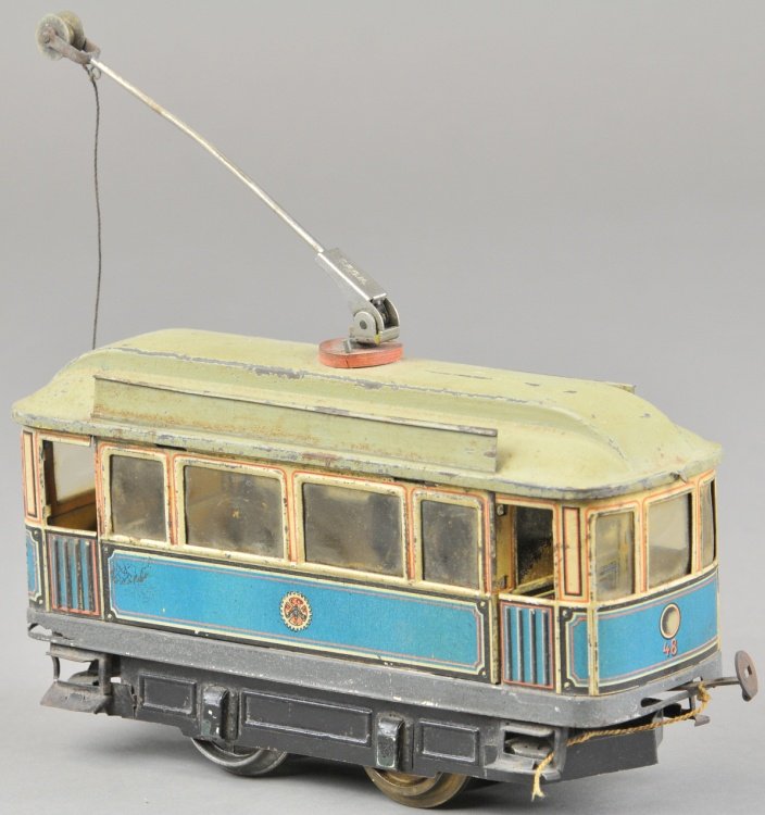 I GAUGE CARETTE TROLLEY: Germany, electric tram done in lithographed body, green painted opening hinged roof, clerestory and celluloid windows. 8" l.