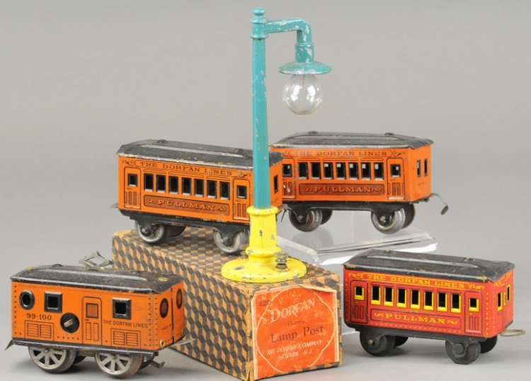 DORFAN 99-100 PASSENGER SET: Lithographed tin set features clockwork box cab loco and two pullmans in brown with added red coach and boxed #420 lamp post. 5" l.