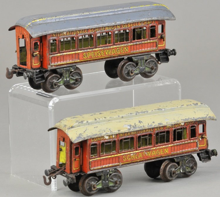 LOT OF TWO BING COACHES: Germany, both lithographed in tin, includes Speisewagon and Schlafwagon, one with blue roof, one with grey roof, eight wheels. 8" l.