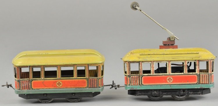 CARETTE O GAUGE TROLLEY & TRAILER: Lithographed tin bodies and painted tin roofs, #35 electric powered trolley features pole on roof. Ex. Krames and Kimball Collections. 6 1/2" l.