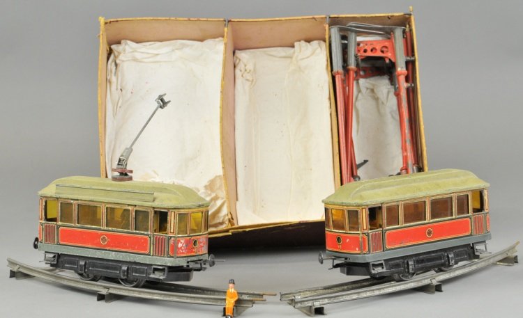 I GAUGE CARETTE TROLLEYS W/TRACK & POLES: Germany, electric power car and trailer car, both done in lithographed tin, red and blue, bodies with greenish roofs, power unit has electric pole on roof, track poles made of tin and form curved sect
