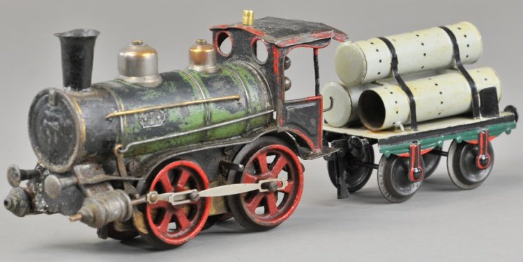 MARKLIN TRAIN LOT: Grouping includes 0-4-0 I gauge European outline engine, a small single arc lamp and flat car hauling tank tubes. Car 4 1/4" l, Loco 7 1/2" l.