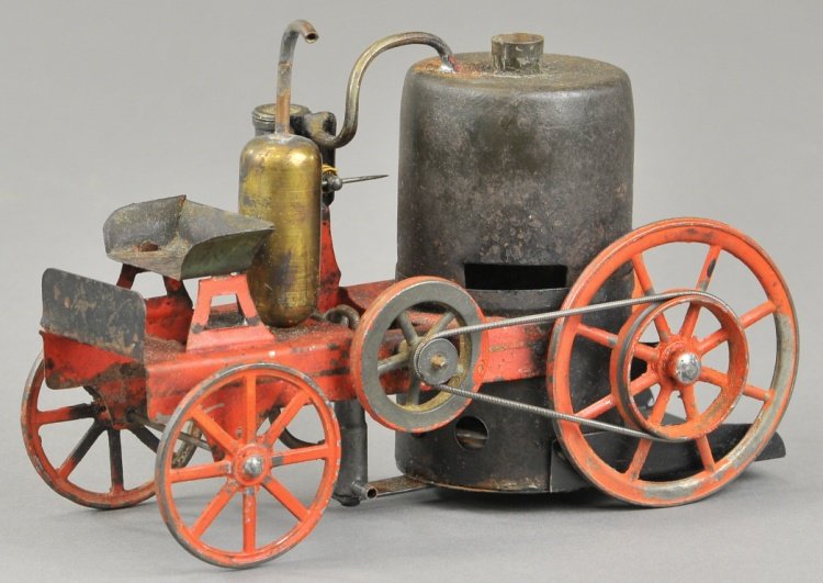 LIVE STEAM FIRE PUMPER: Schoenner, early German made live steam fire truck, done in red hand painted tin with cast metal spoke wheels, unusual form, features high bench open seat. 6 1/2" l.