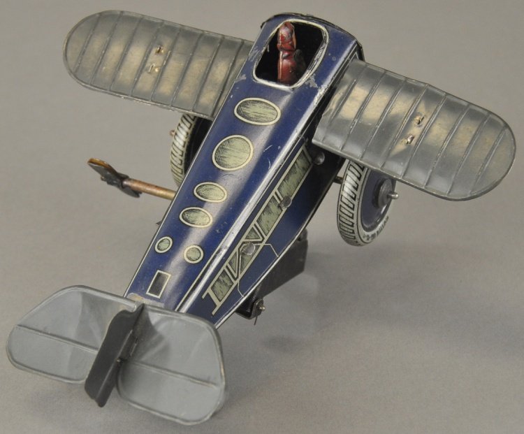 GUNTHERMANN ROLLOVER PLANE: Lithographed tin, blue fuselage, clockwork plane with pilot, features undercarriage bar to allow plane to roll then pop up. 6 1/2" l.