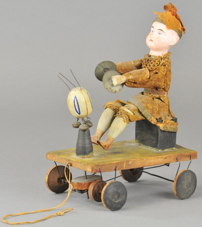 ARTICULATED CHINESE BOY FLOOR TOY: Bisque head, painted features, posed on wooden block with cymbals in hand, articulated action. 6" l.