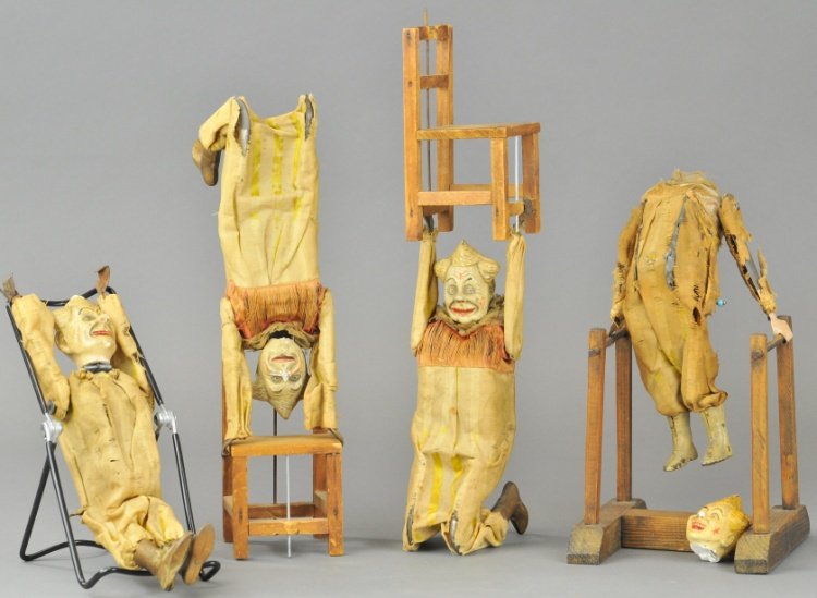 AUTO CIRCUS PERFORMING CLOWNS: Features clown and non-mechanized clown, both in cloth outfits, hand painted composition heads, each able to stand on wood chairs, ladder. 10" l.